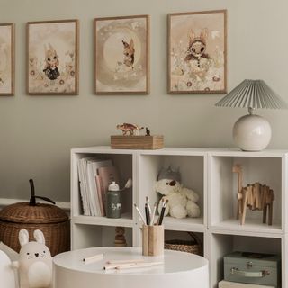 Framed illustrated animal prints hanging on the wall of a kids' playroom