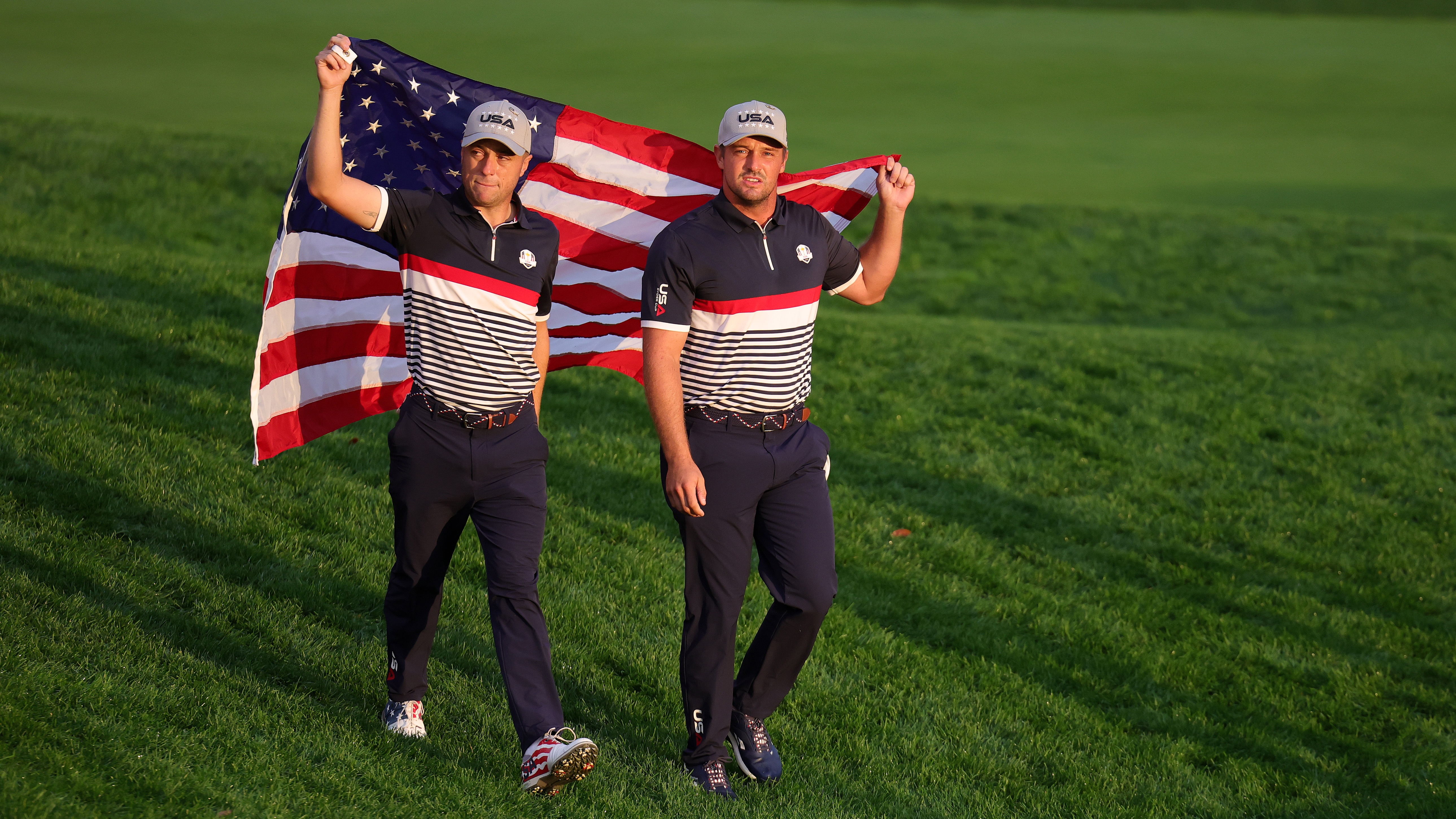 Justin Thomas and Bryson DeChambeau of Team United States walk to the first tee during the Friday morning foursomes matches of the 2025 Ryder Cup at Black Course at Bethpage State Park Golf Course on September 26, 2025 in Farmingdale, New York.
