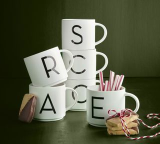 Six Stackable Alphabet mugs with candy canes in the letter 'E' mug