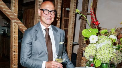 Stanley Tucci holding a martini glass