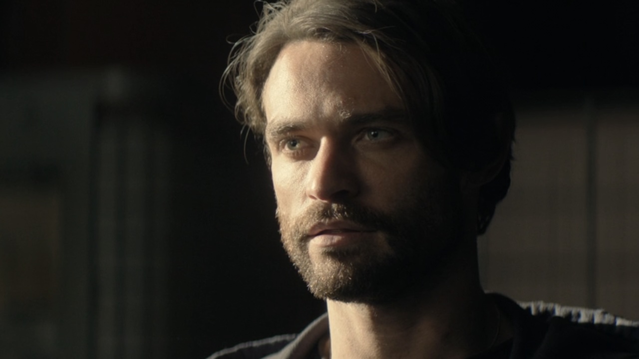 Close-up of Link's face as he talks to Sinatra in hangar in Paradise Season 2 Episode 7