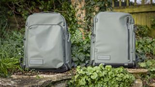light green camera backpacks against wooden greenery background