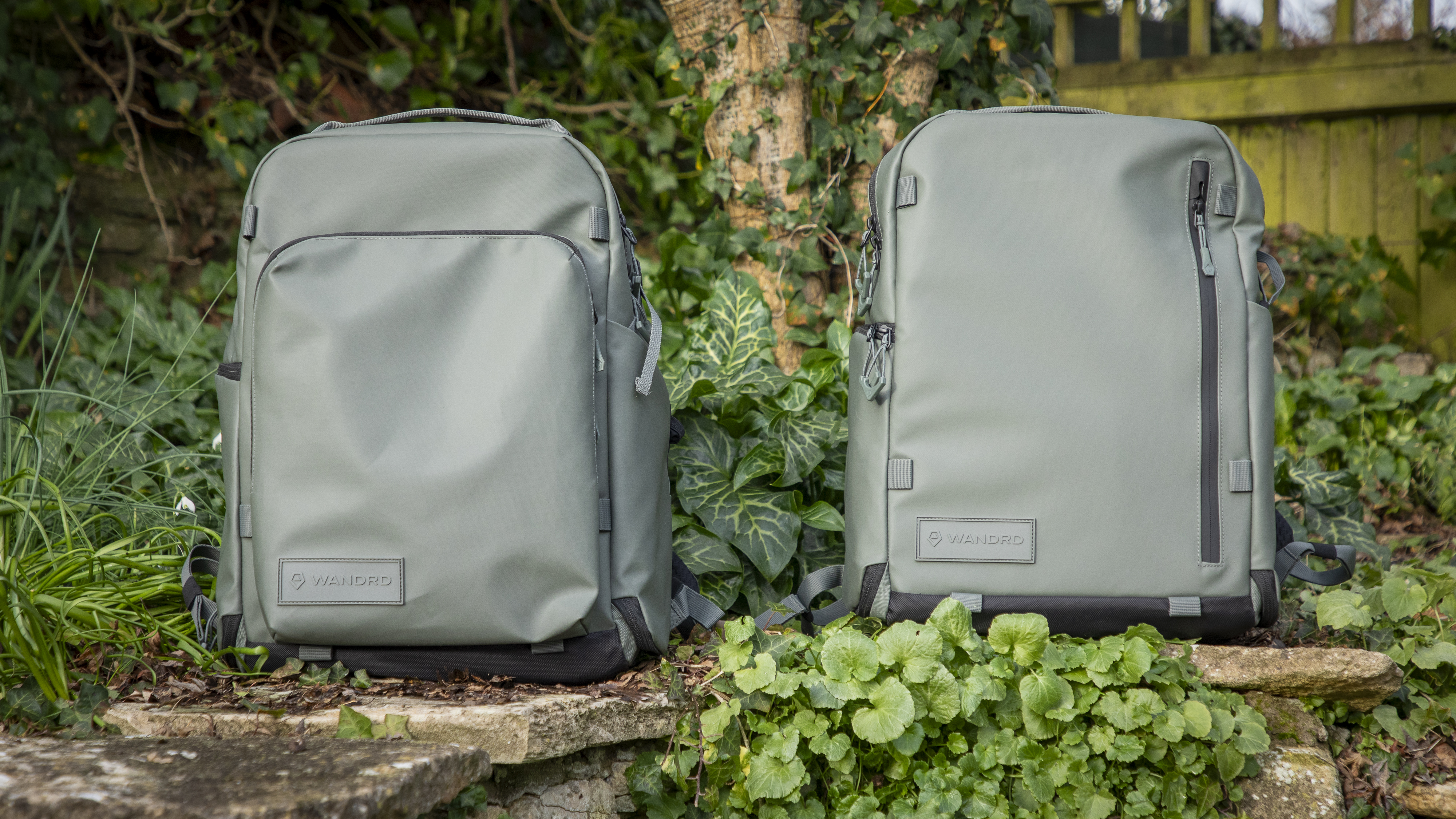 light green camera backpacks against wooden greenery background