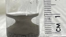 a close-up of a material that forms a shape like a Grecian urn in a test tube