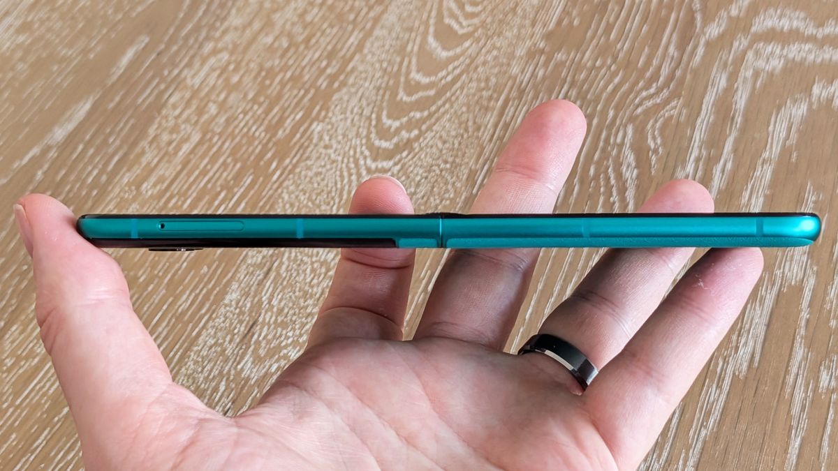 Motorola Razr 2026 in blue, being held in the hand
