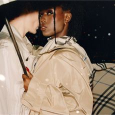 a woman wears a Burberry trench coat