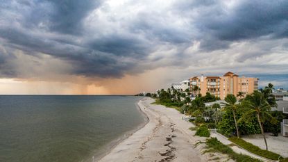A beach town in Florida with a storm looming in the ocean.