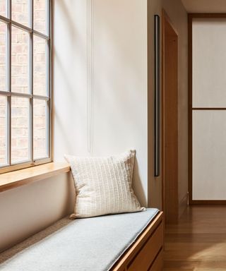 A seating nook by a large window in a Japandi-style space