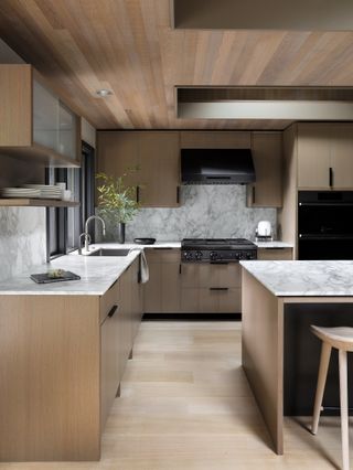 minimalist kitchen with wood flooring and cabinets