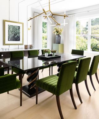 dining room with black furniture wooden floor and garden view
