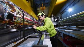  Makoto Fujiwara stands in front of ALPHA Experiment apparatus at CERN in Switzerland.