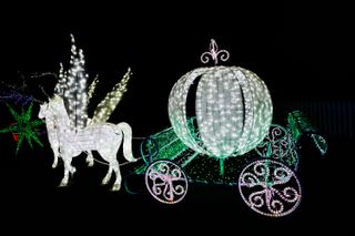 Christmas light display of a two-horse round carriage
