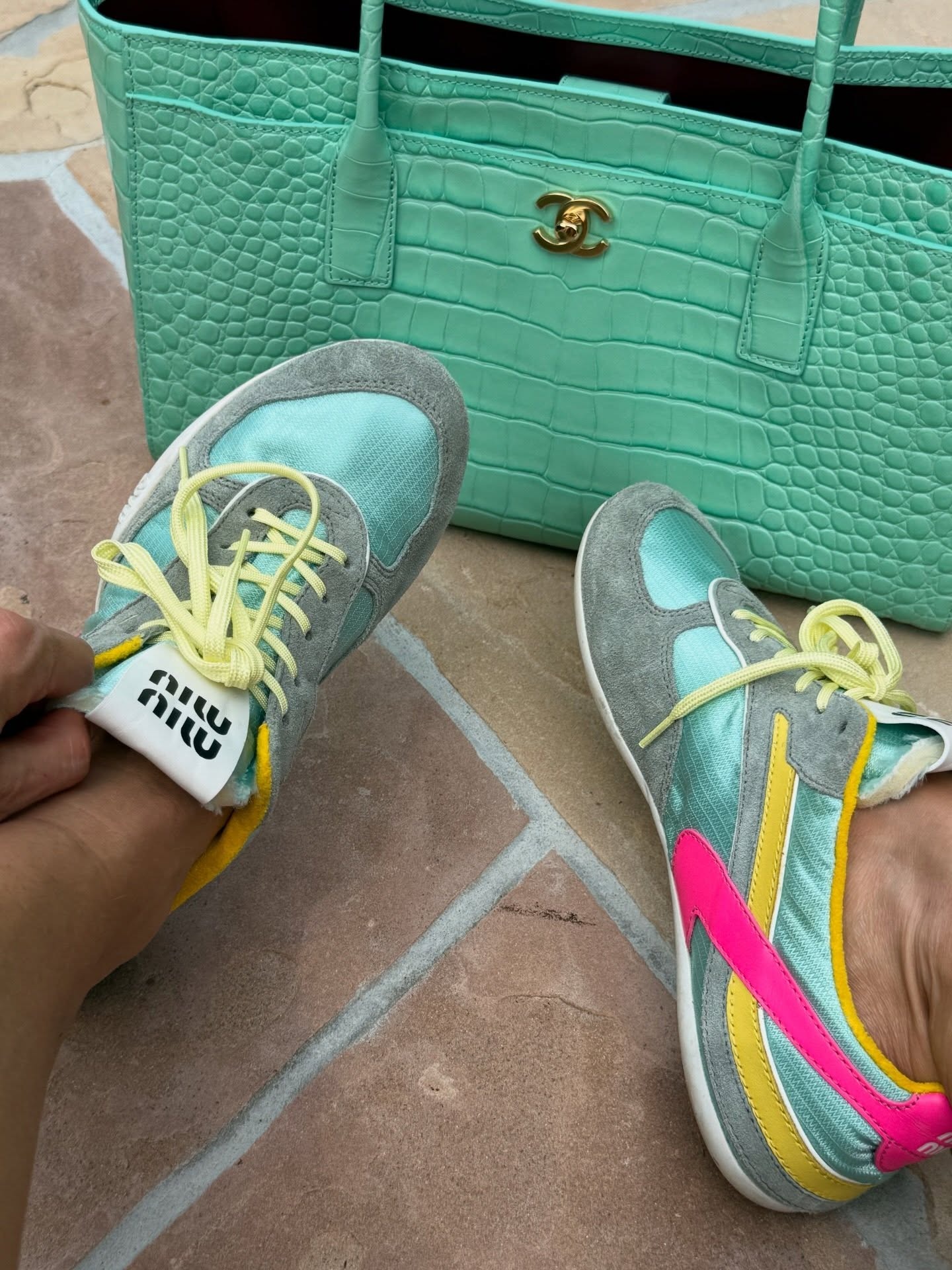 Elsa Hosk wearing the D&amp;Ocirc;EN Cicely Dress, mint green Chanel Small Tote, and Miu Miu Gymnasium Sneakers