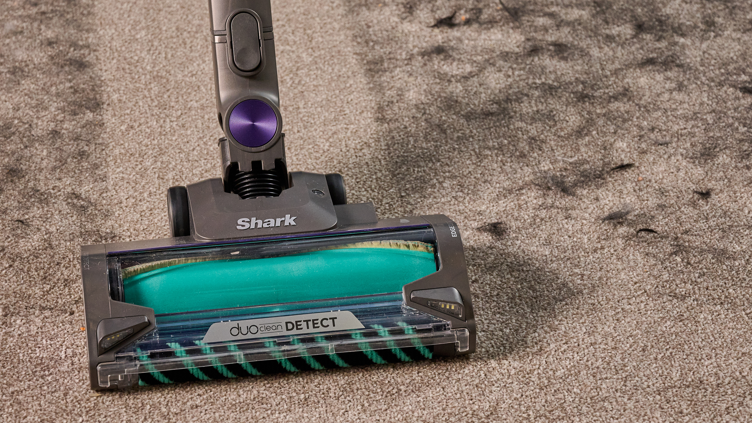 Shark PowerDetect cordless vacuum clearing dog hair from a carpet