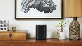 Sonos One smart speaker in black colourway on wooden desk