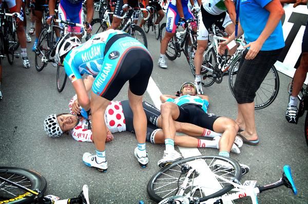 A Milram rider checks on Haussler after his crash.