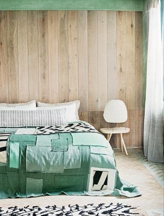 Scandinavian inspired bedroom with wood paneling