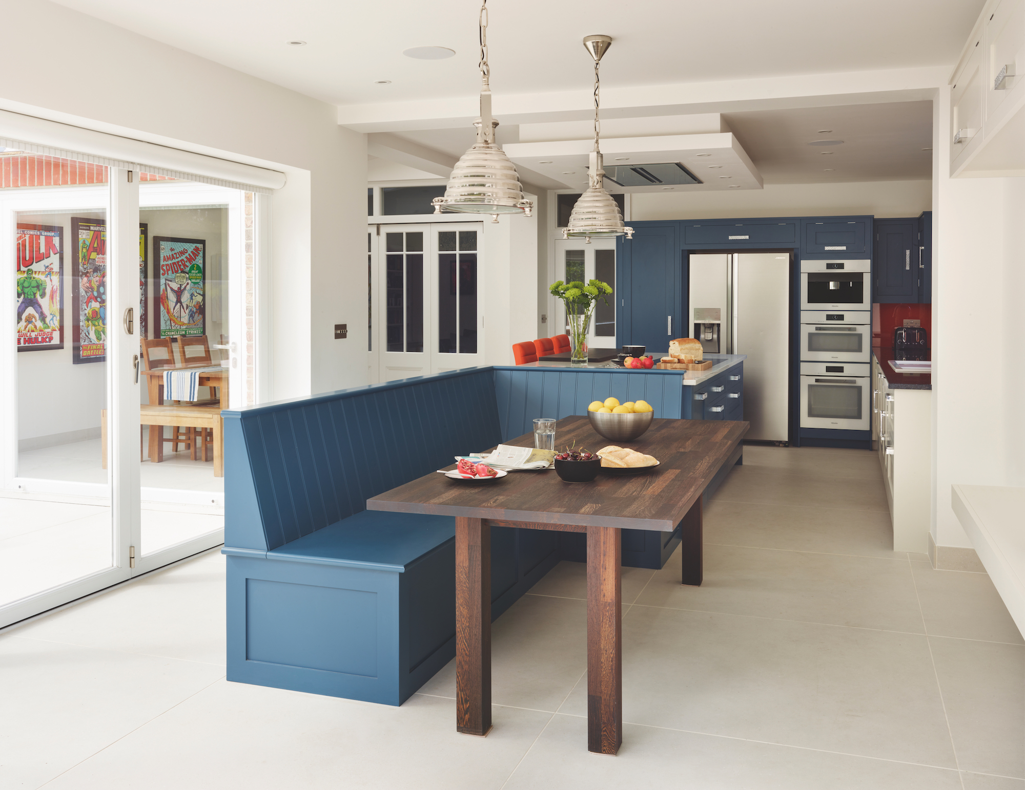 blue open plan kitchen with built in seating