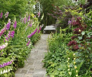 Reclaimed natural stone laid as a pathway in a garden with cottage style planting