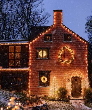 Brick house lit up for Christmas with warm white lights