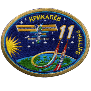 a patch showing the international space station above earth beside the number 11