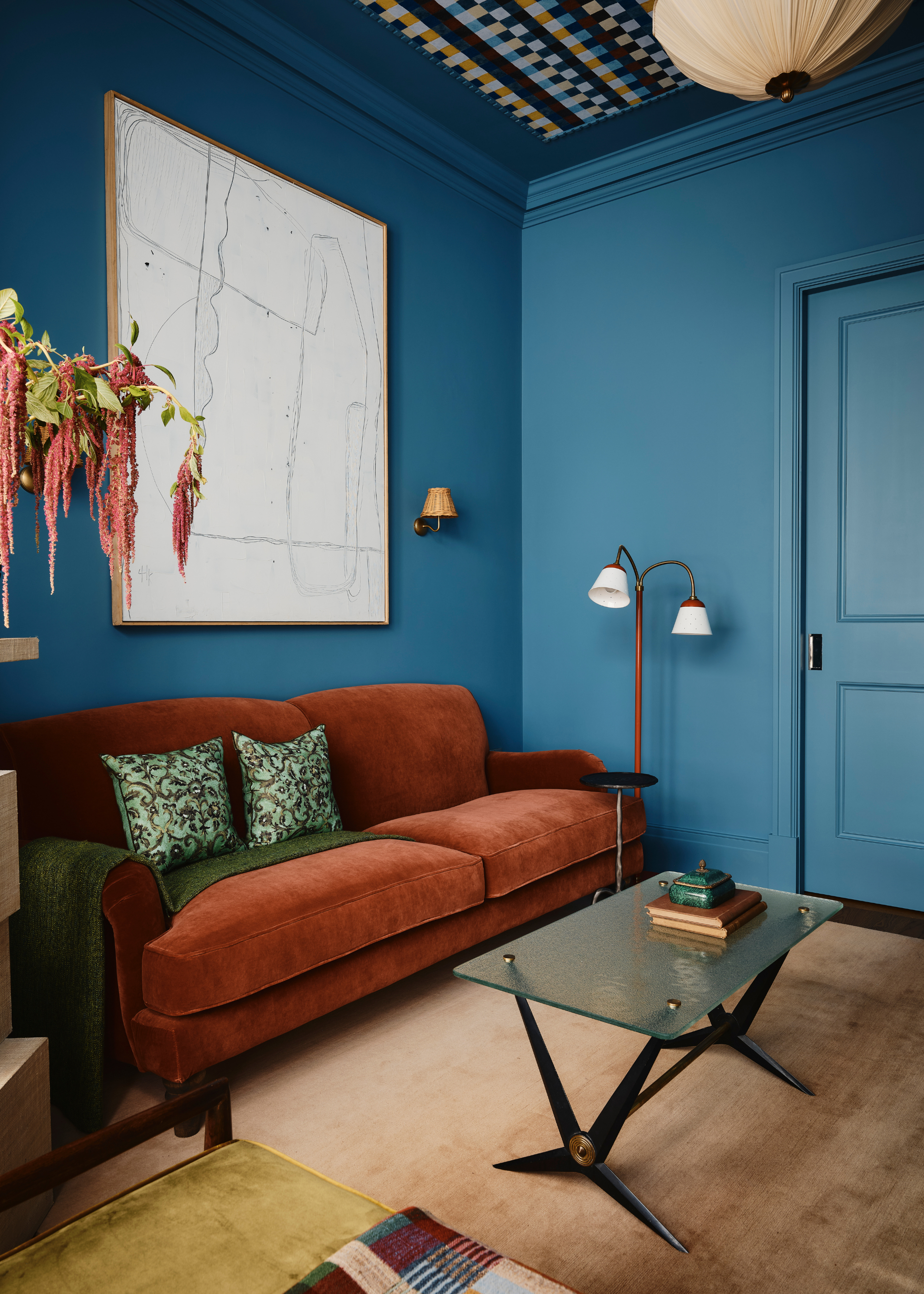 A terracotta sofa in a blue living room
