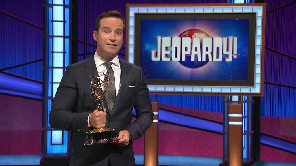 Mike Richards holding an Emmy