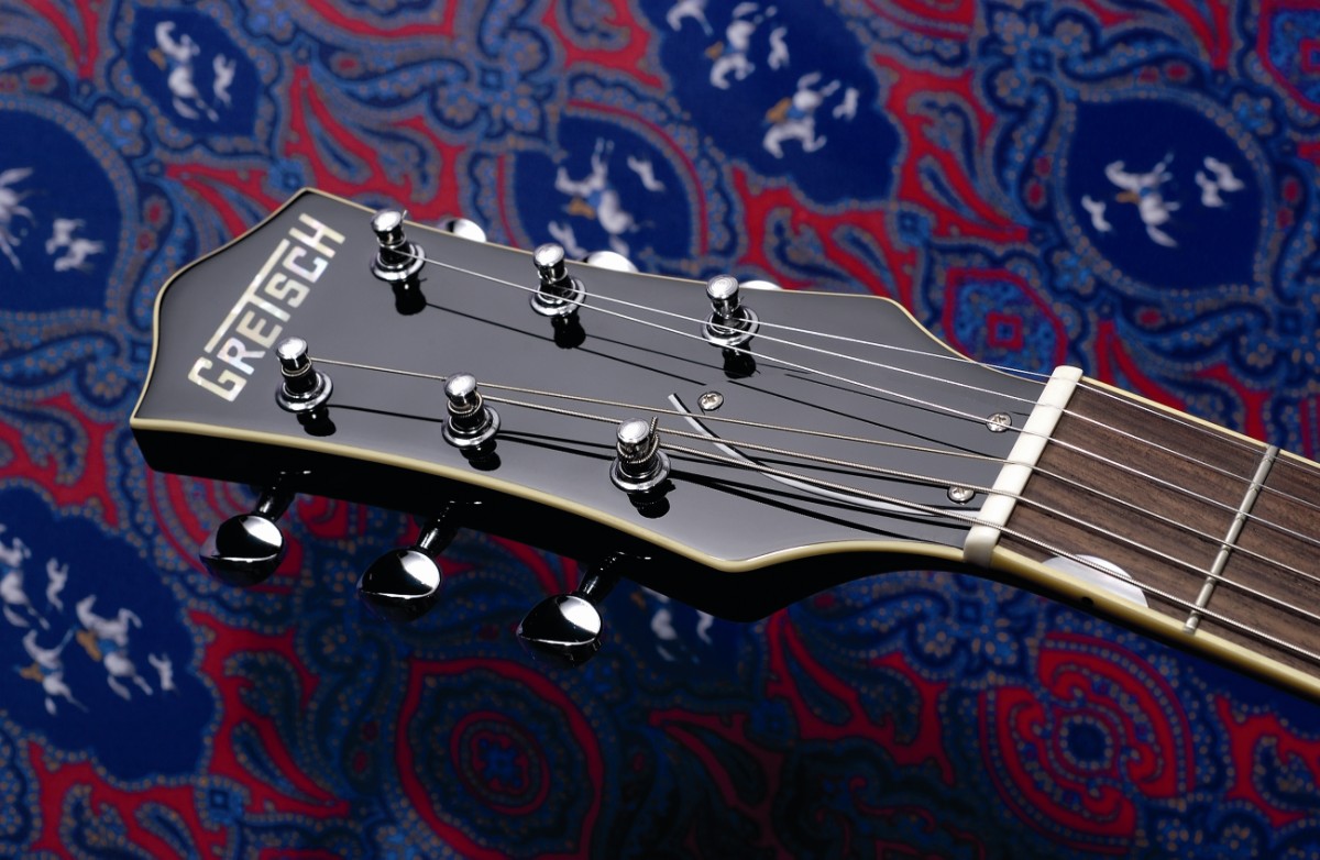 The cream binding is cleanly nicely rolled into the fingerboard.
