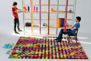 Pixel art: Two men, a bookcase and a rug based on a pixel design