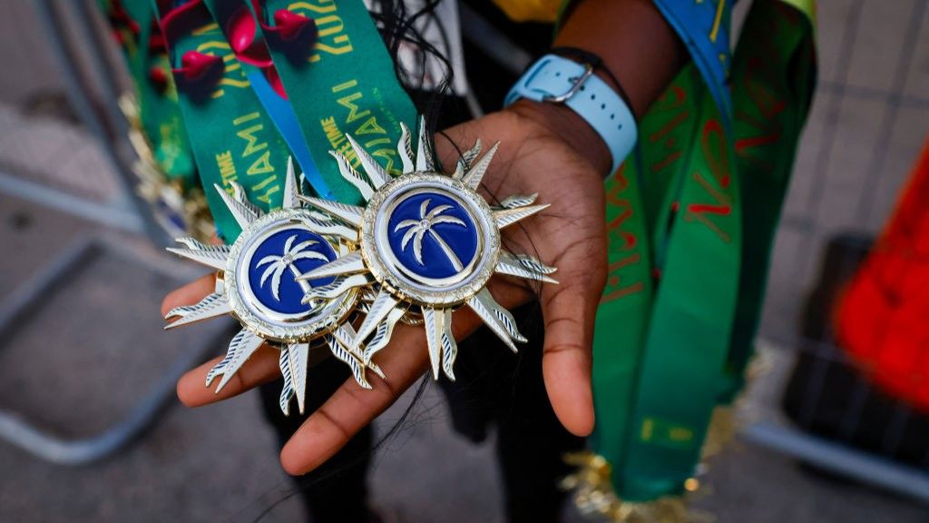 Two spiky medals from the 2024 Miami Marathon