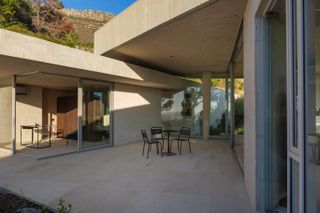 Shaded patio at concrete mountain house in South Africa