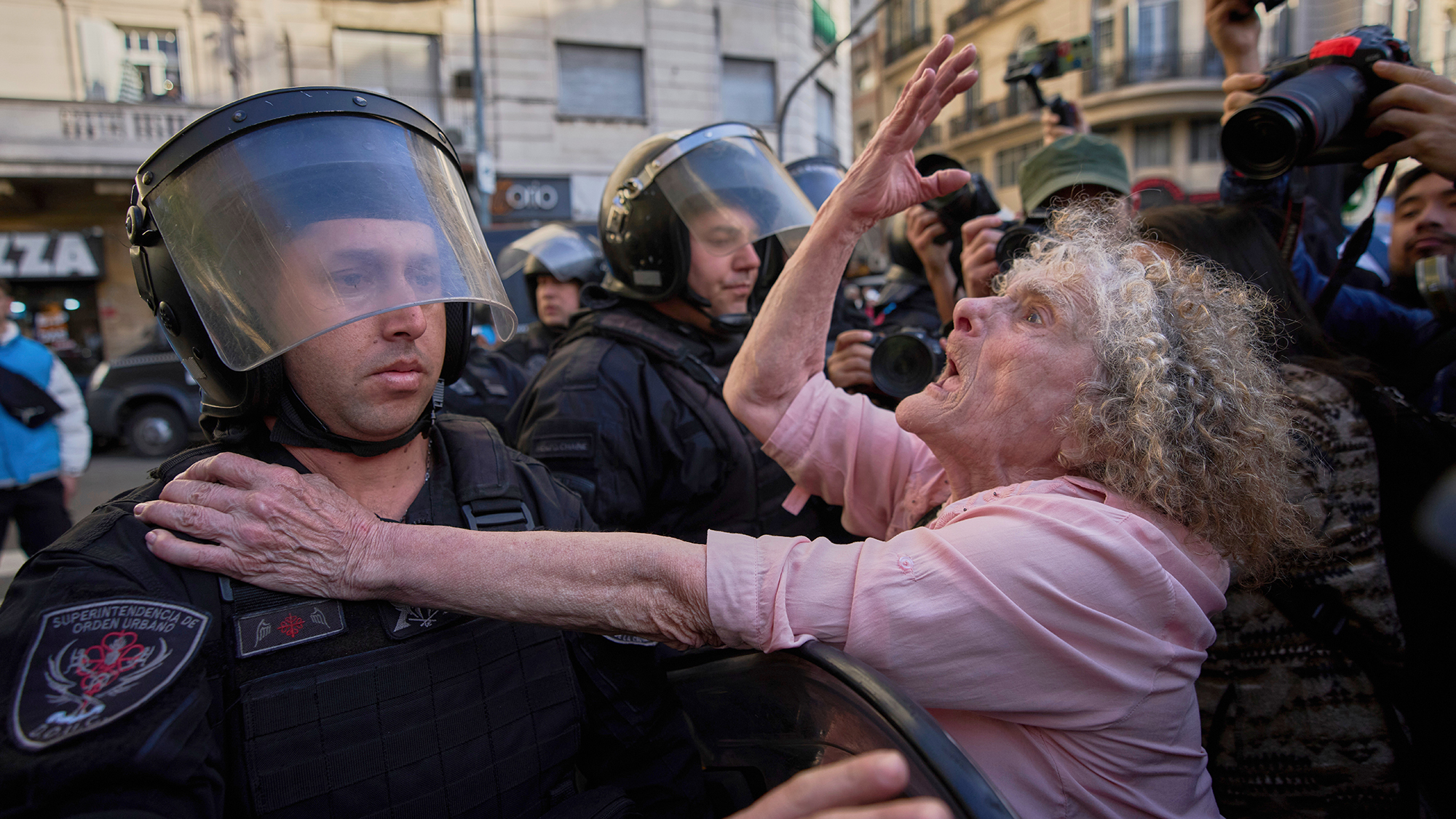 A woman pleads with police during a protest over better pensions for retirees, in Buenos Aires, Argentina