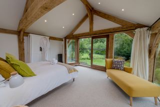 large master bedroom with glazing and vaulted ceiling