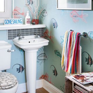 bathroom with seaside themed wallpaper