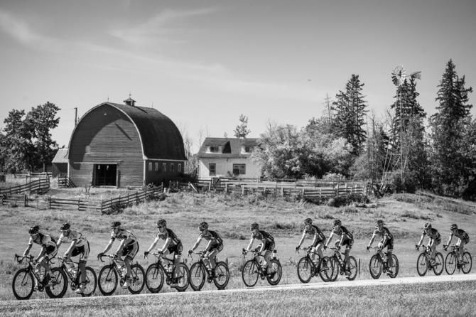 The peloton passes a farm out on today's route.