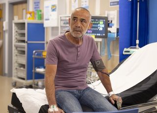 Kevin Webster sitting on a hospital bed