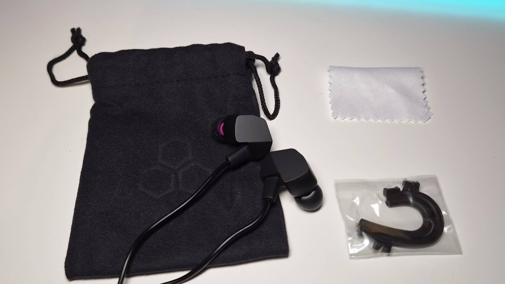 Photo of the accessories included with the Final VR3000 Gaming Earphones sitting on a white desk.