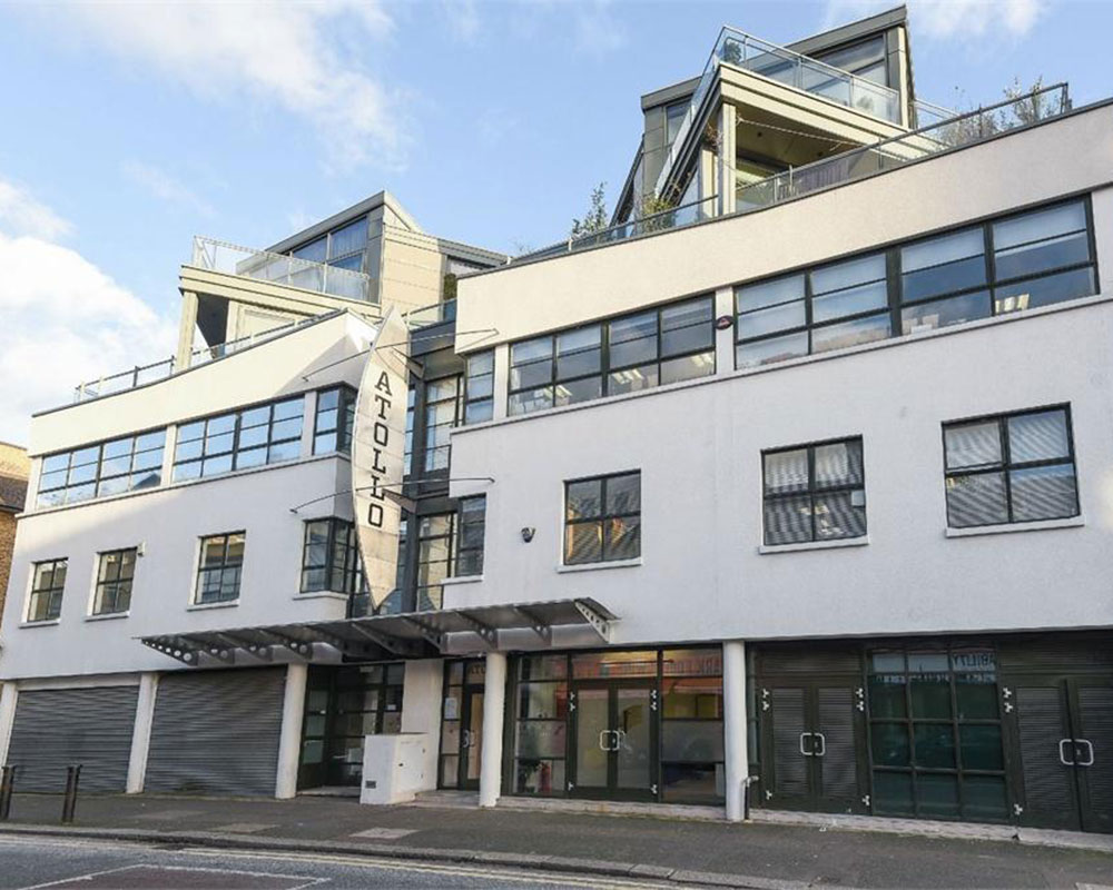 white multistoried building with grey doors and windows