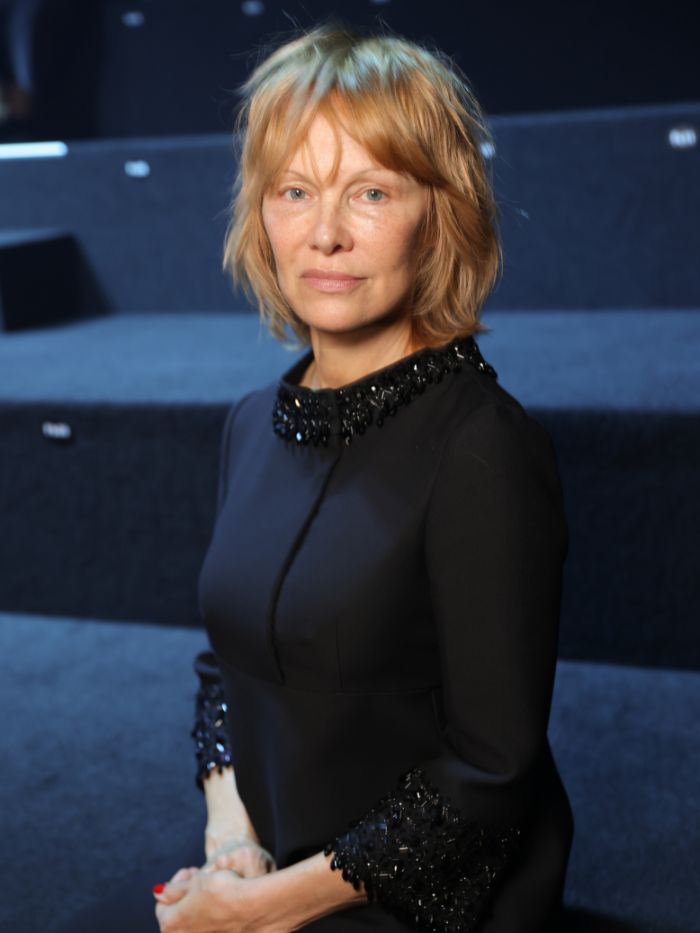 Pamela Anderson at the Valentino show as part of Paris Fashion Week with copper blonde hair