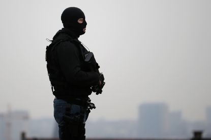 A member of the special police forces stands guard outside the Council Chamber of Brussels on March 24.