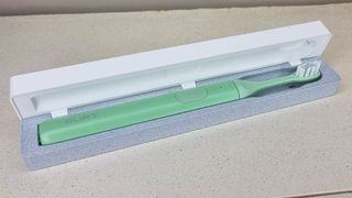 SURI Sustainable Electric Toothbrush in an open travel case