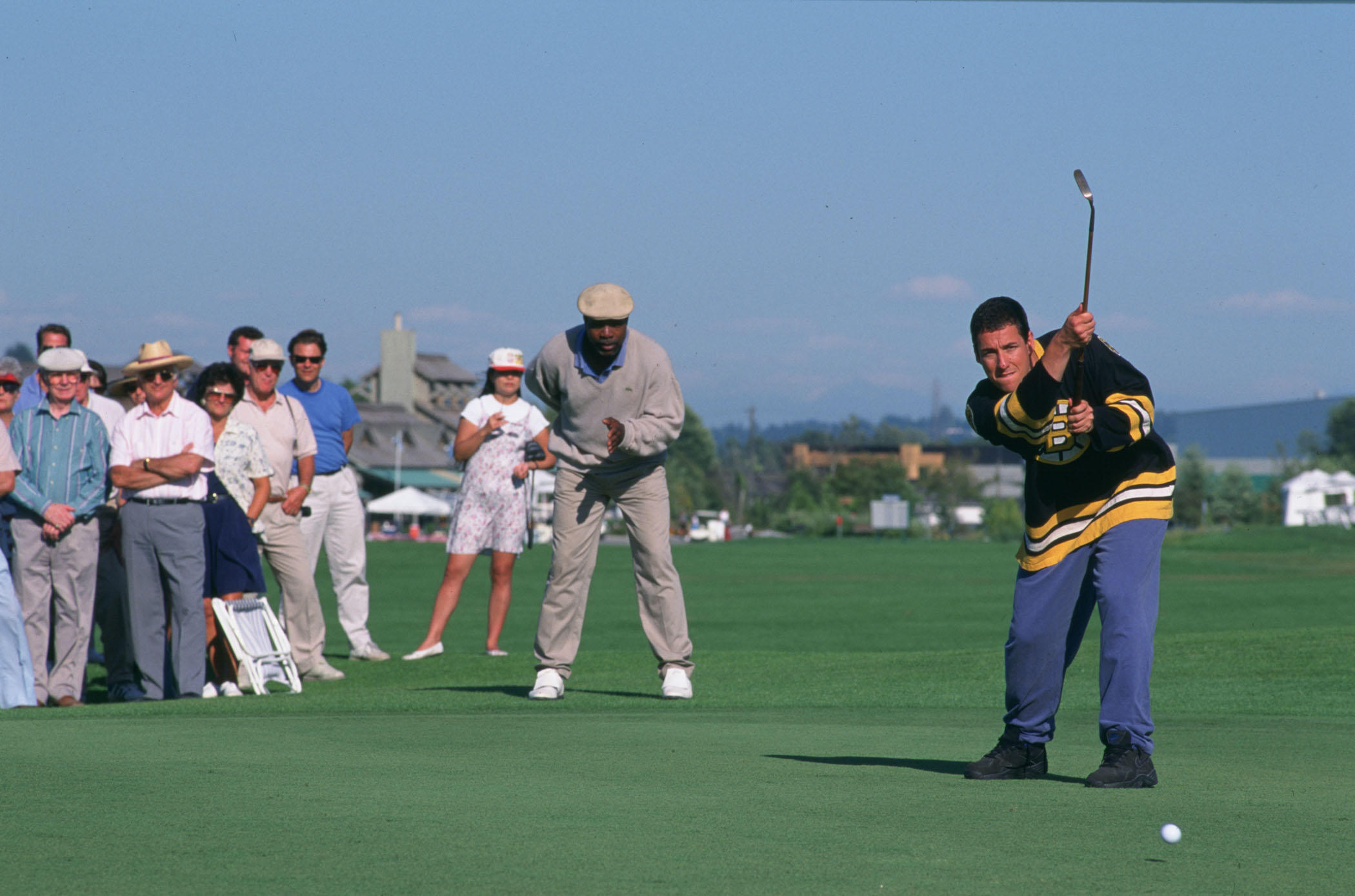 Adam Sandler wears a hockey jersey while playing golf in 'Happy Gilmore'