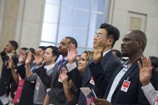 A group of immigrants become naturalized as U.S. citizens. 