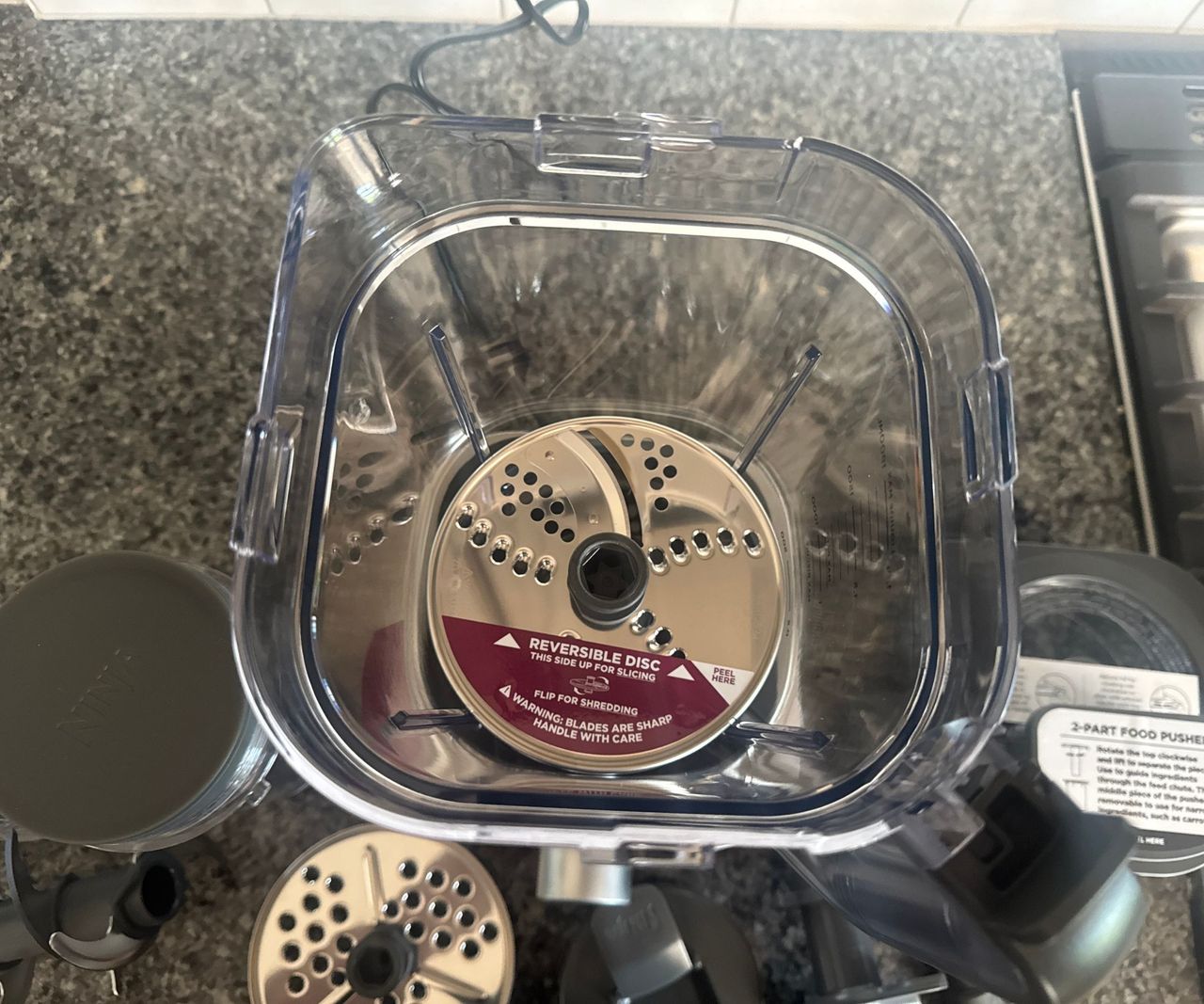 A top-down view of one of the slicing attachments on the Ninja Foodi Power Blender Ultimate System inside the pitcher.