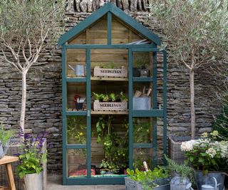 mini wooden greenhouse painted dark green