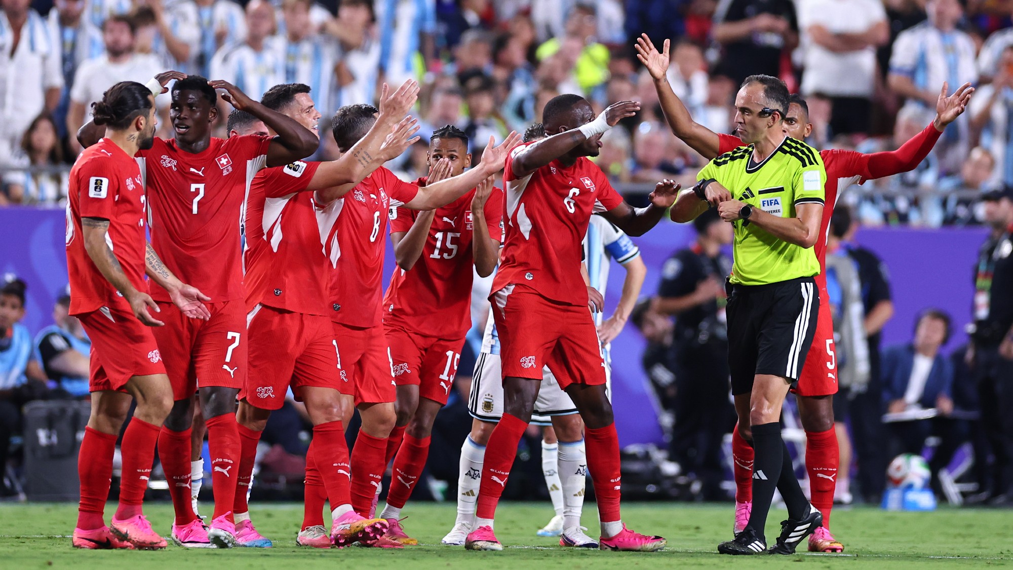 Switzerland players react after Breel Embolo is sent off for a second yellow following a VAR mistaken identity review
