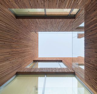 Interior facades of striped leftover Spruce-Pine-Fir (SPF) create an intricate vertical timber pattern
