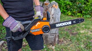 The WORX WG303.1 being carried by a log.