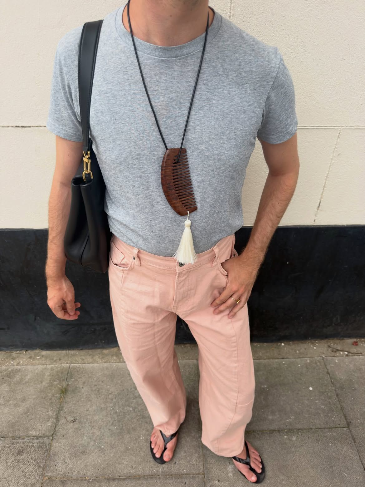 Woman wearing a gray T-shirt outfit.
