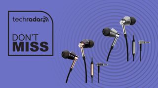 1More Triple Driver In-Ear Headphones in gold and silver on a violet background with words &#039;TechRadar: Don&#039;t Miss&#039; positioned to the left 